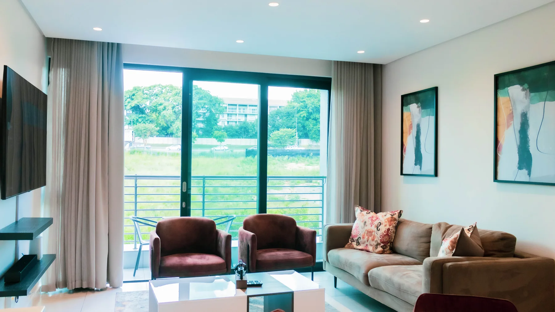 Furnished living room opening toward the balcony in Unit 113